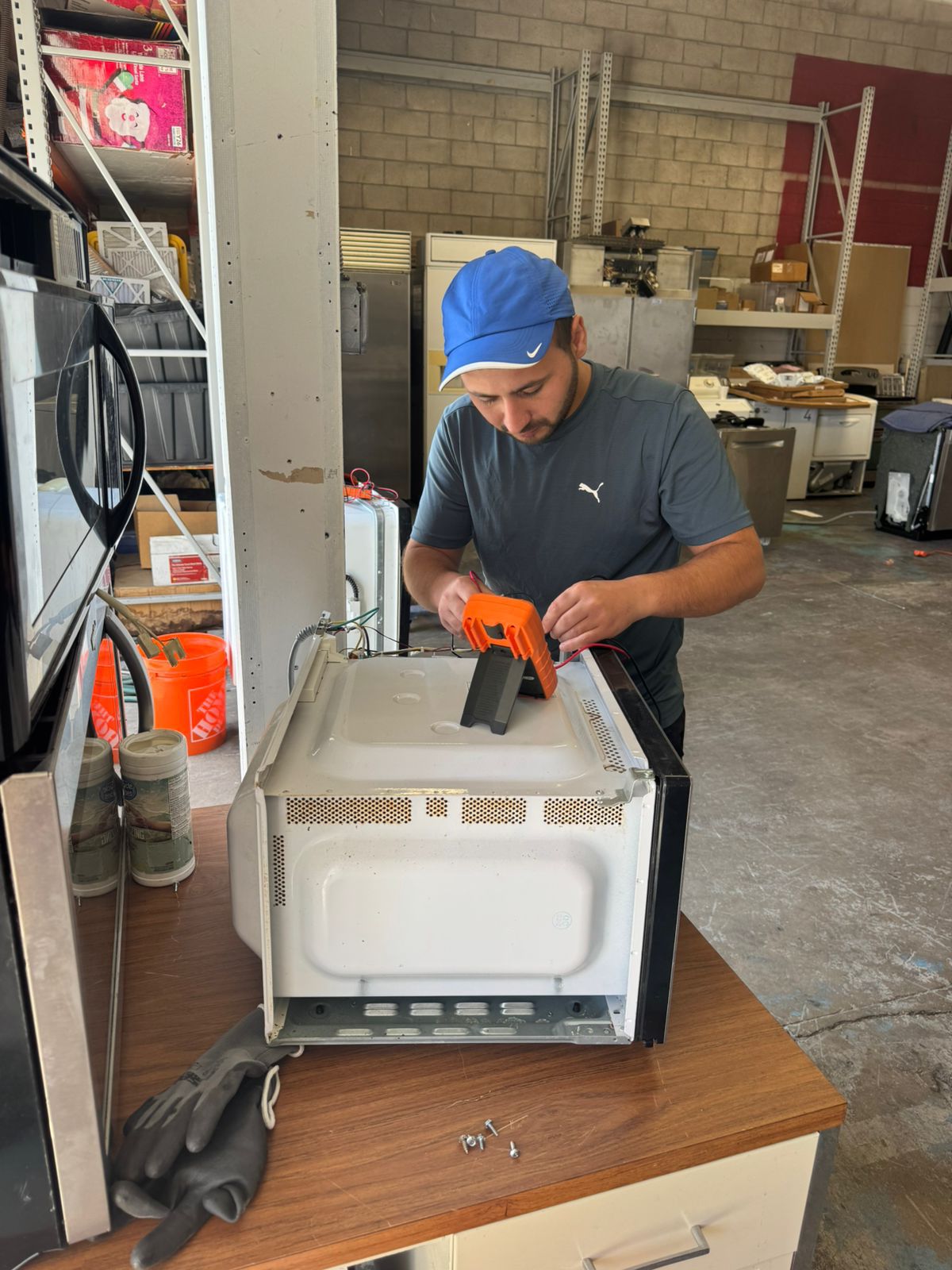 Repix Bay Area microwave repair technician working on control board
